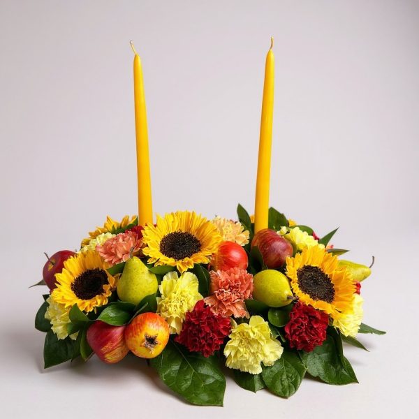Thanksgiving sunflower centerpiece with candles and fall flowers on lush greenery