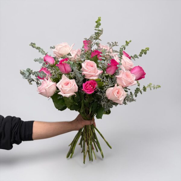 Pink rose bouquet with blush roses, hot pink roses, eucalyptus, delicate filler flower, and fresh greenery hand-tied by Quinn Florist